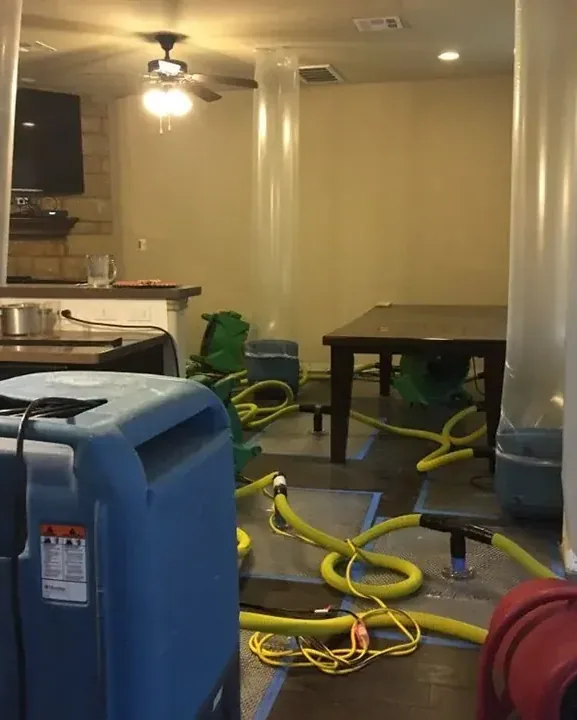 Extraction hoses and drying equipment arranged inside a furnished room