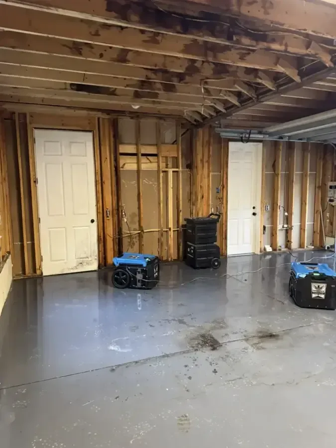 Dehumidifiers positioned in an opened lower level during structural drying