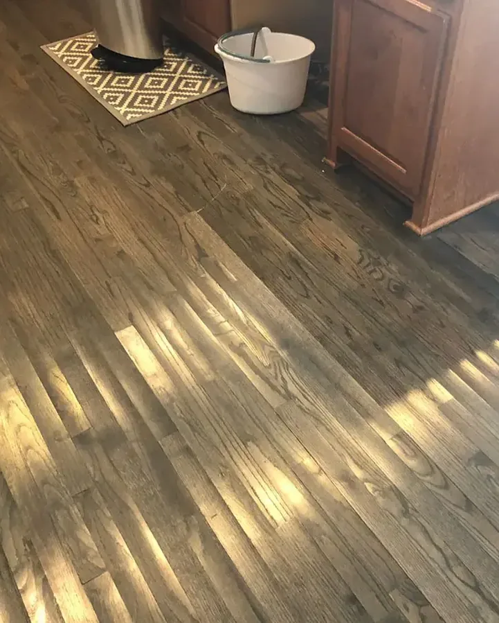 Cupped wood floor boards after a water leak in a kitchen